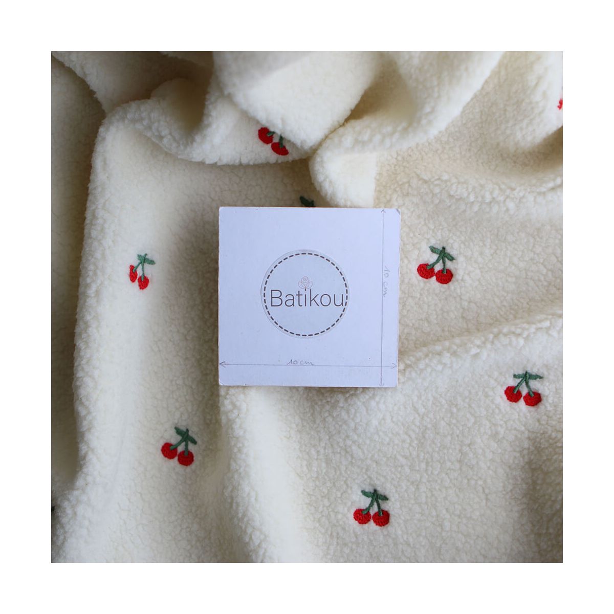 Teddy / moumoute bouclé fond écru broderies cerises