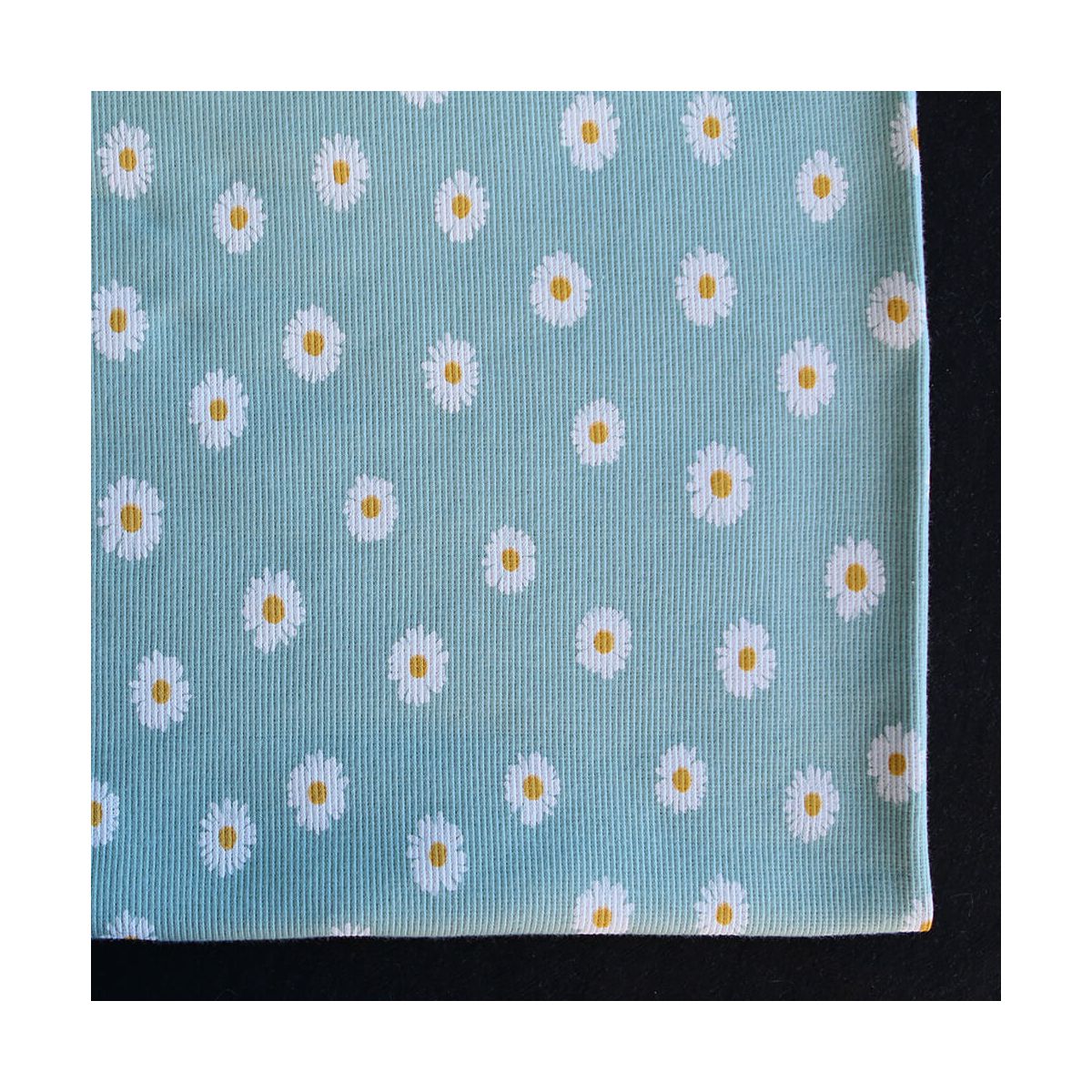 Jersey coton côtes fines à motif marguerites sur fond vert tendre