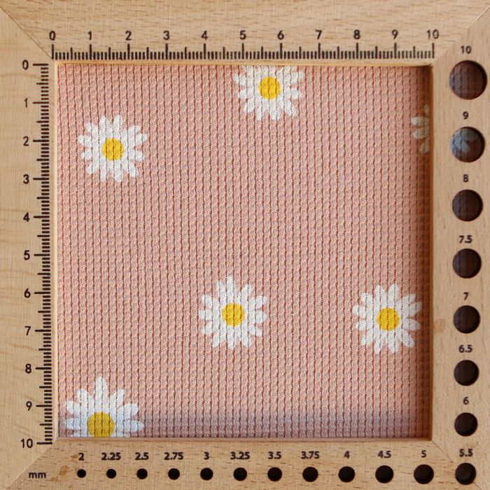 Jersey coton côtes fines à motif marguerites sur fond pêche nude