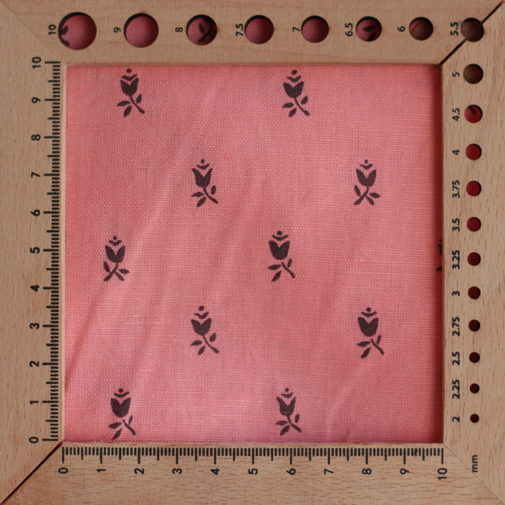 Lola - Tissu lin coton fond corail clair petits motifs noirs