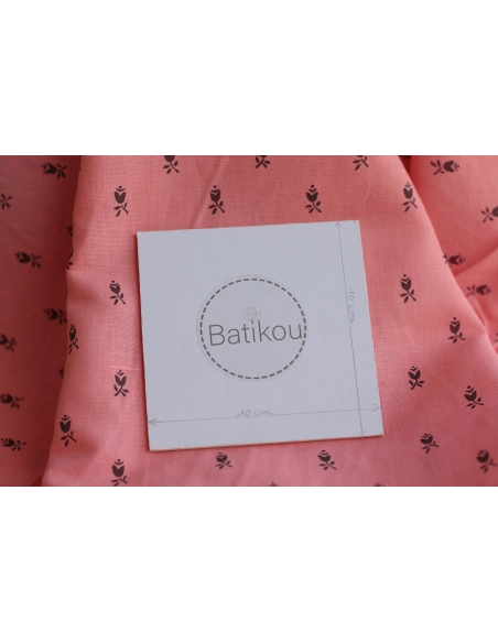 Lola - Tissu lin coton fond corail clair petits motifs noirs