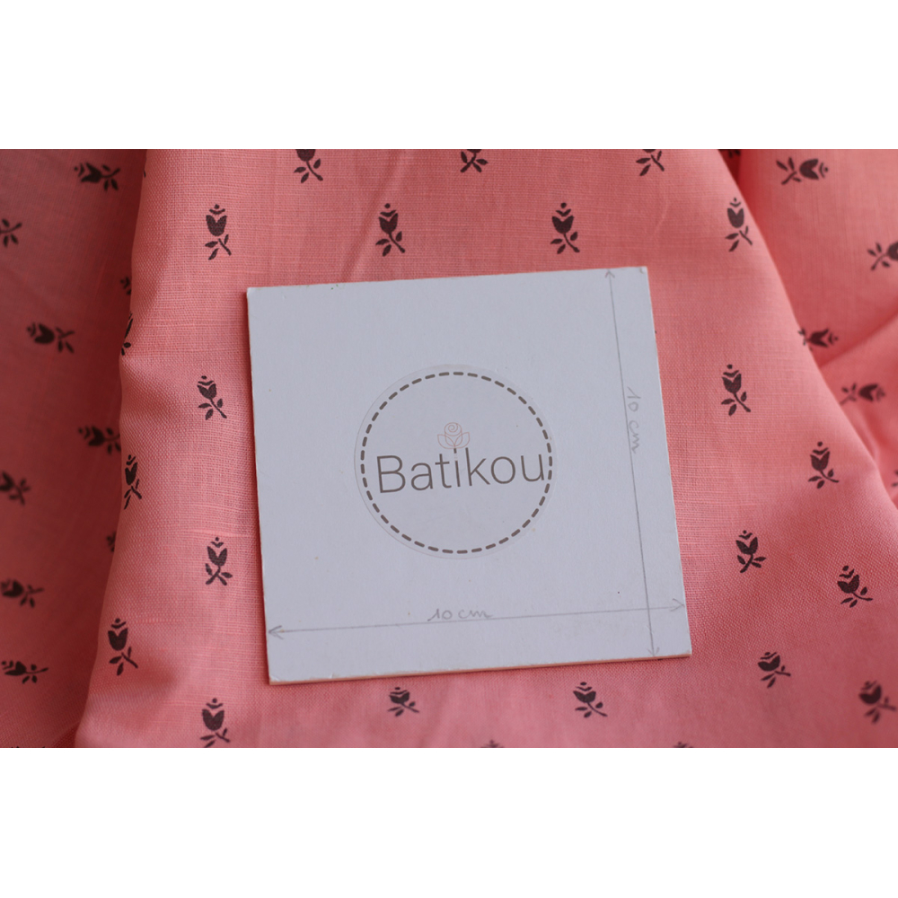 Lola - Tissu lin coton fond corail clair petits motifs noirs