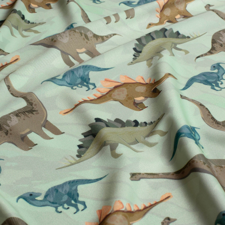 Tissu Lycra (maillot de bain) UPF50 dinosaures sur fond vert clair Tissu Lycra (maillot de bain) UPF50 dinosaures sur fond vert clair