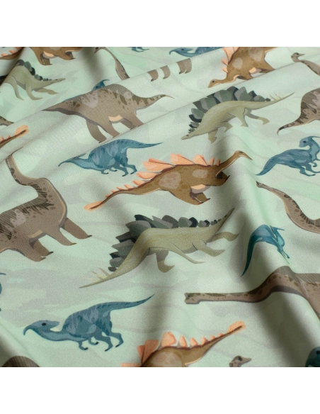 Tissu Lycra (maillot de bain) UPF50 dinosaures sur fond vert clair