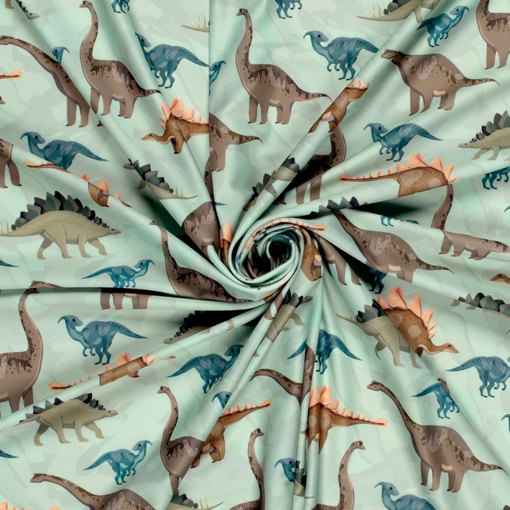 Tissu Lycra (maillot de bain) UPF50 dinosaures sur fond vert clair