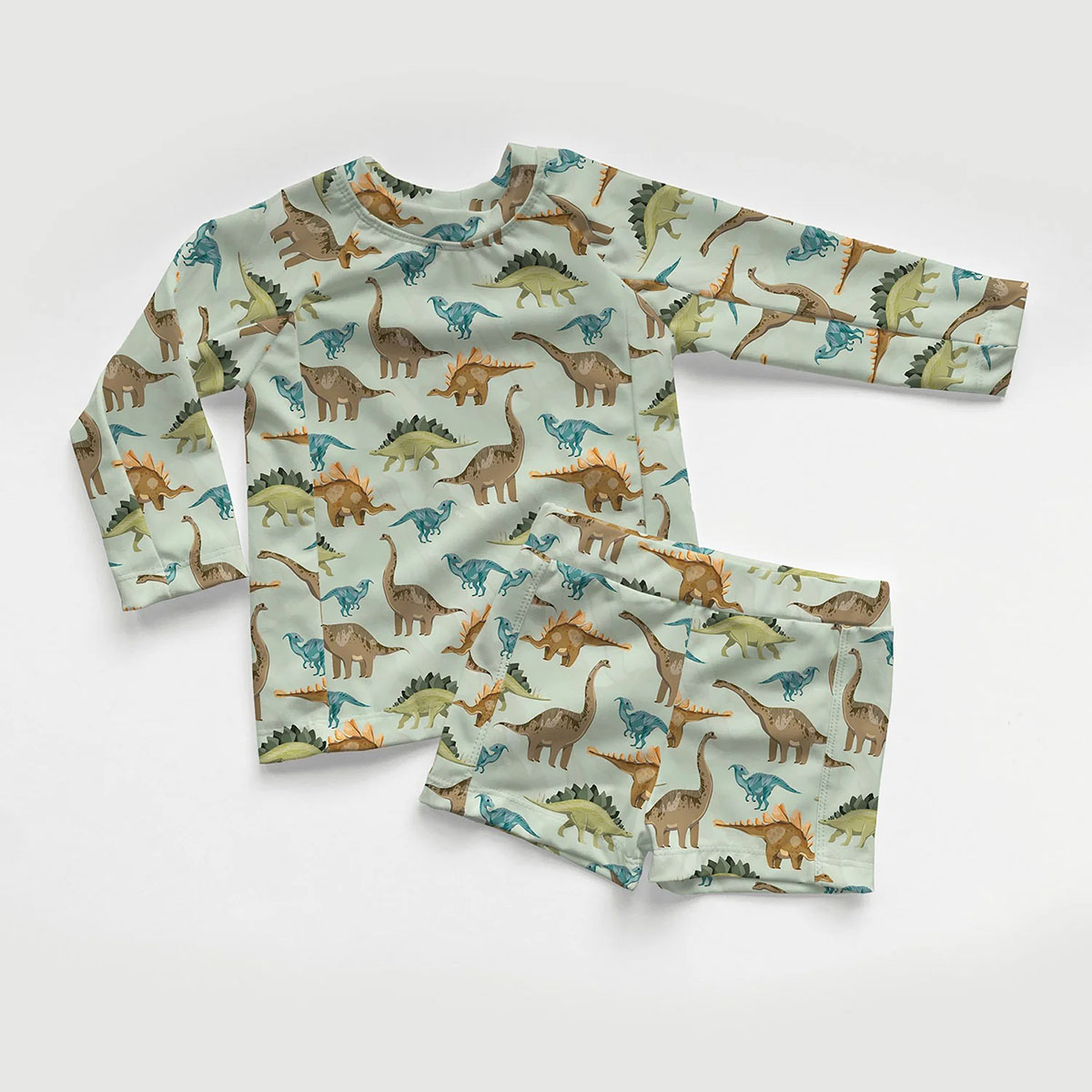 Tissu Lycra (maillot de bain) UPF50 dinosaures sur fond vert clair Tissu Lycra (maillot de bain) UPF50 dinosaures sur fond vert clair