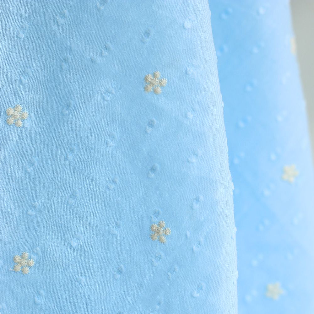 Voile plumetis de coton broderies motif crème coloris bleu ciel Voile plumetis de coton broderies motif crème coloris bleu ciel