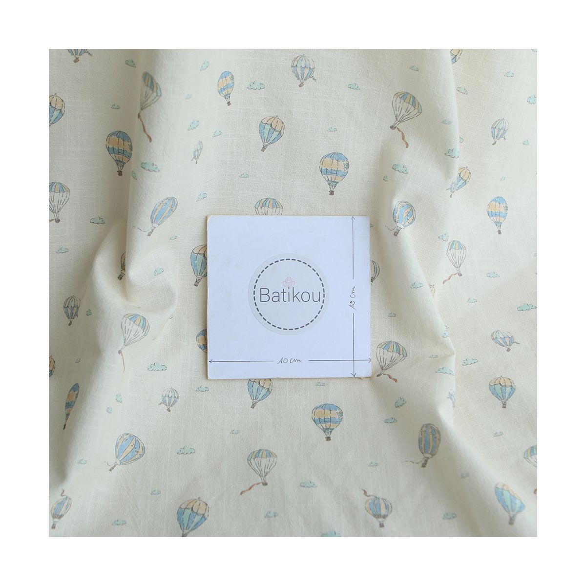 Fergusson - Coton lavé bio coloris vanille motif montgolfière Fergusson - Coton lavé bio coloris vanille motif montgolfière