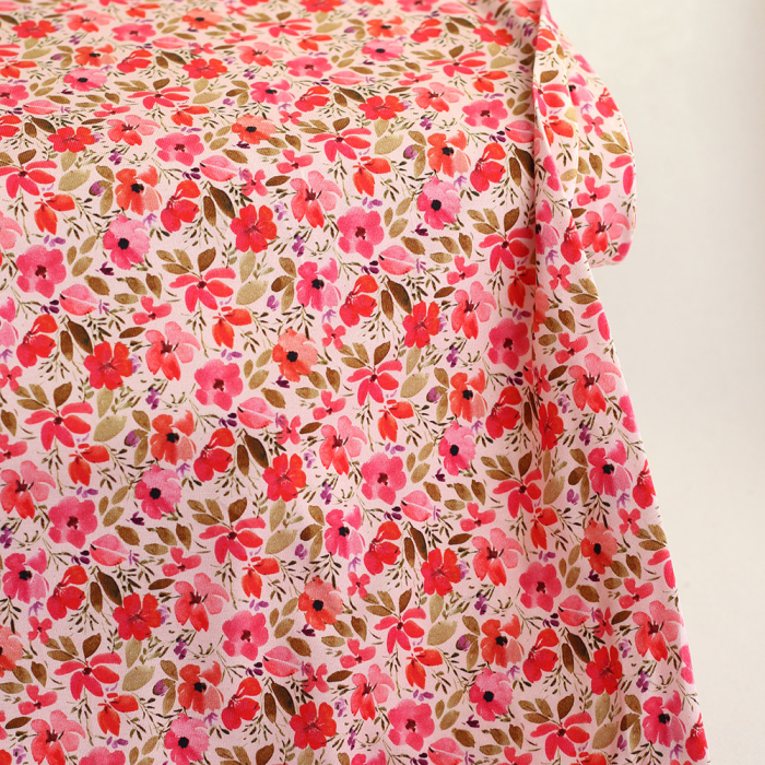 Jersey coton à motif fleuri rose
