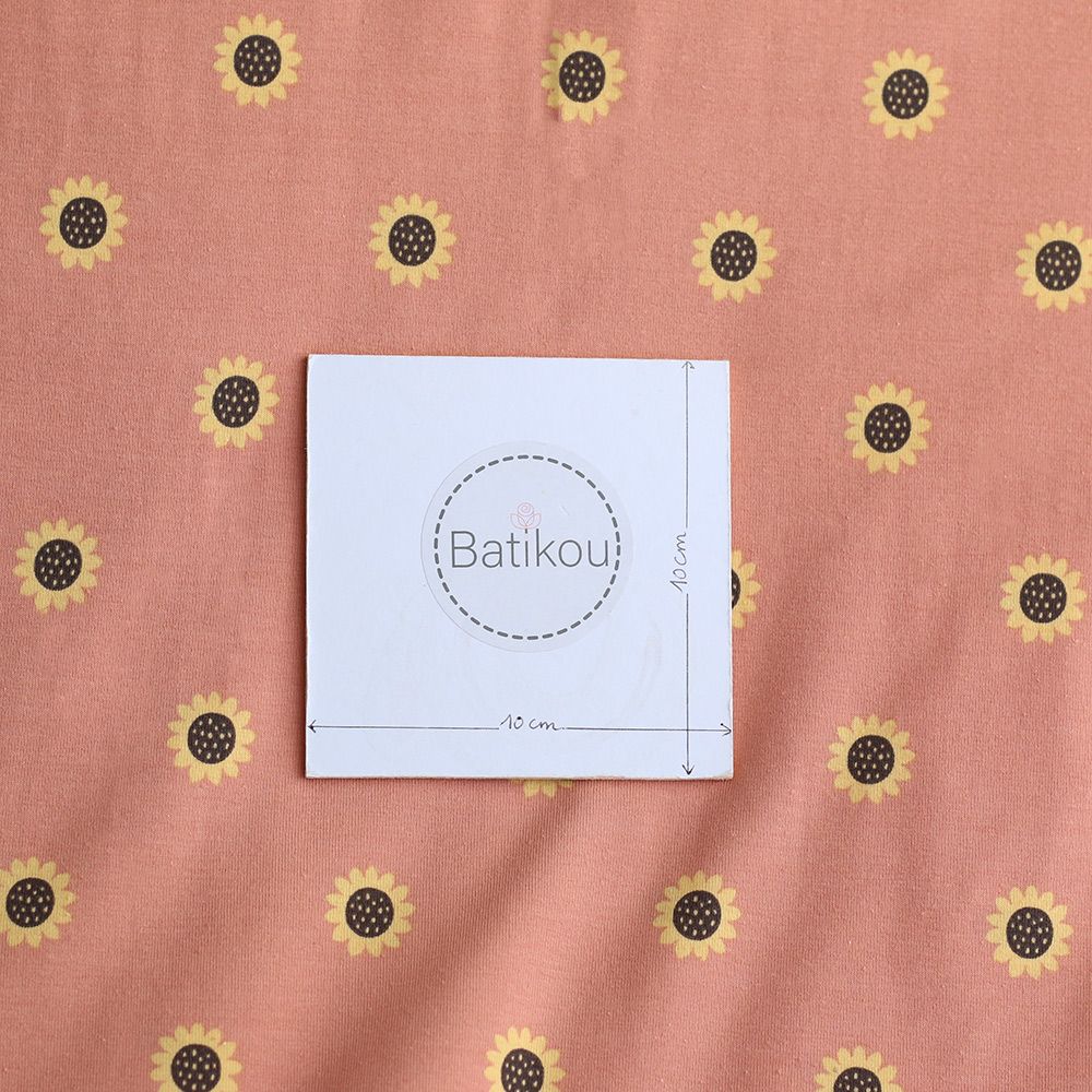 Jersey coton à motif fleurs de tournesol fond tomette clair