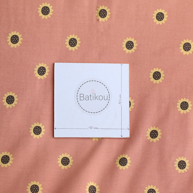 Jersey coton à motif fleurs de tournesol fond tomette clair