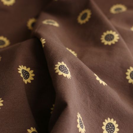 Jersey coton à motif fleurs de tournesol fond chocolat Jersey coton à motif fleurs de tournesol fond chocolat