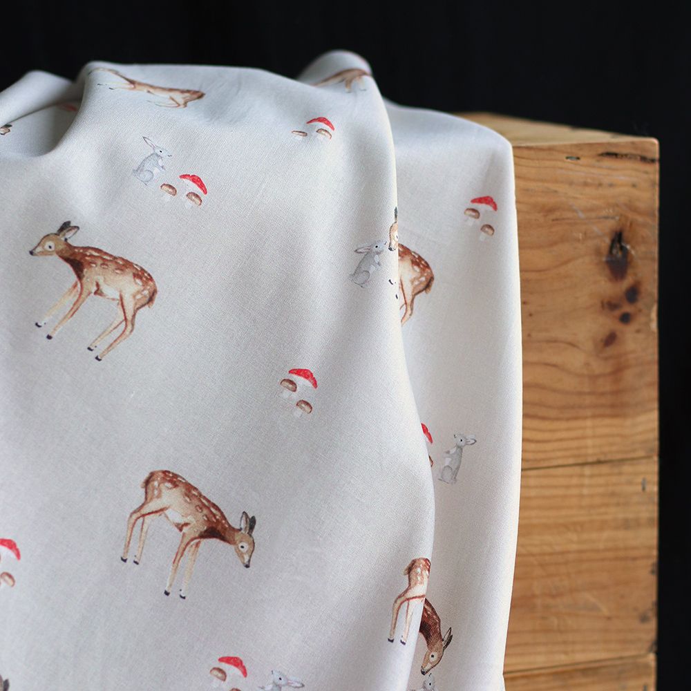 Bambi - Popeline de coton fond beige motif biche, lapin et champignons