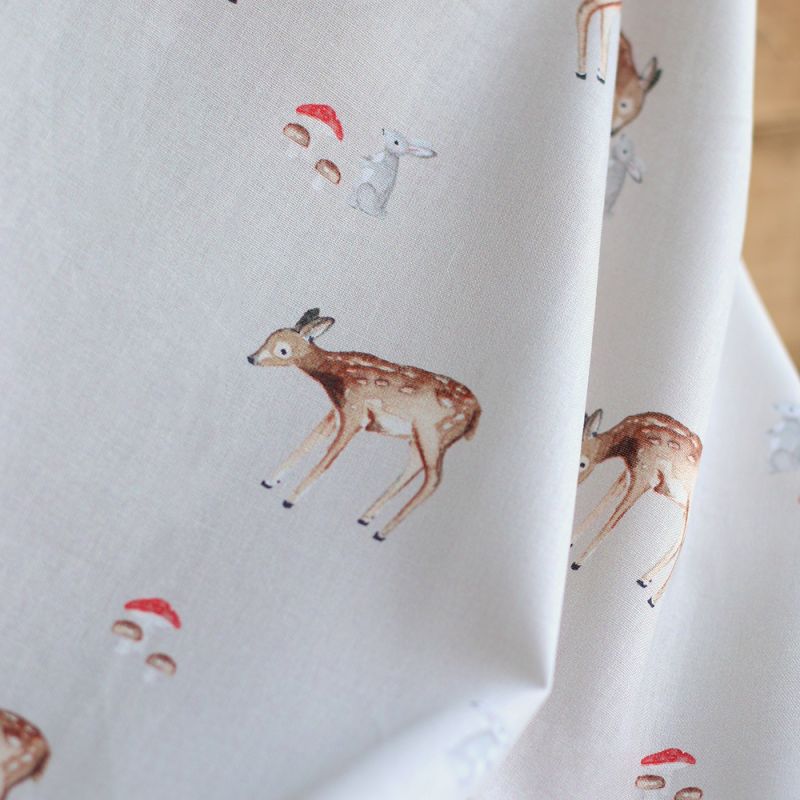 Bambi - Popeline de coton fond beige motif biche, lapin et champignons