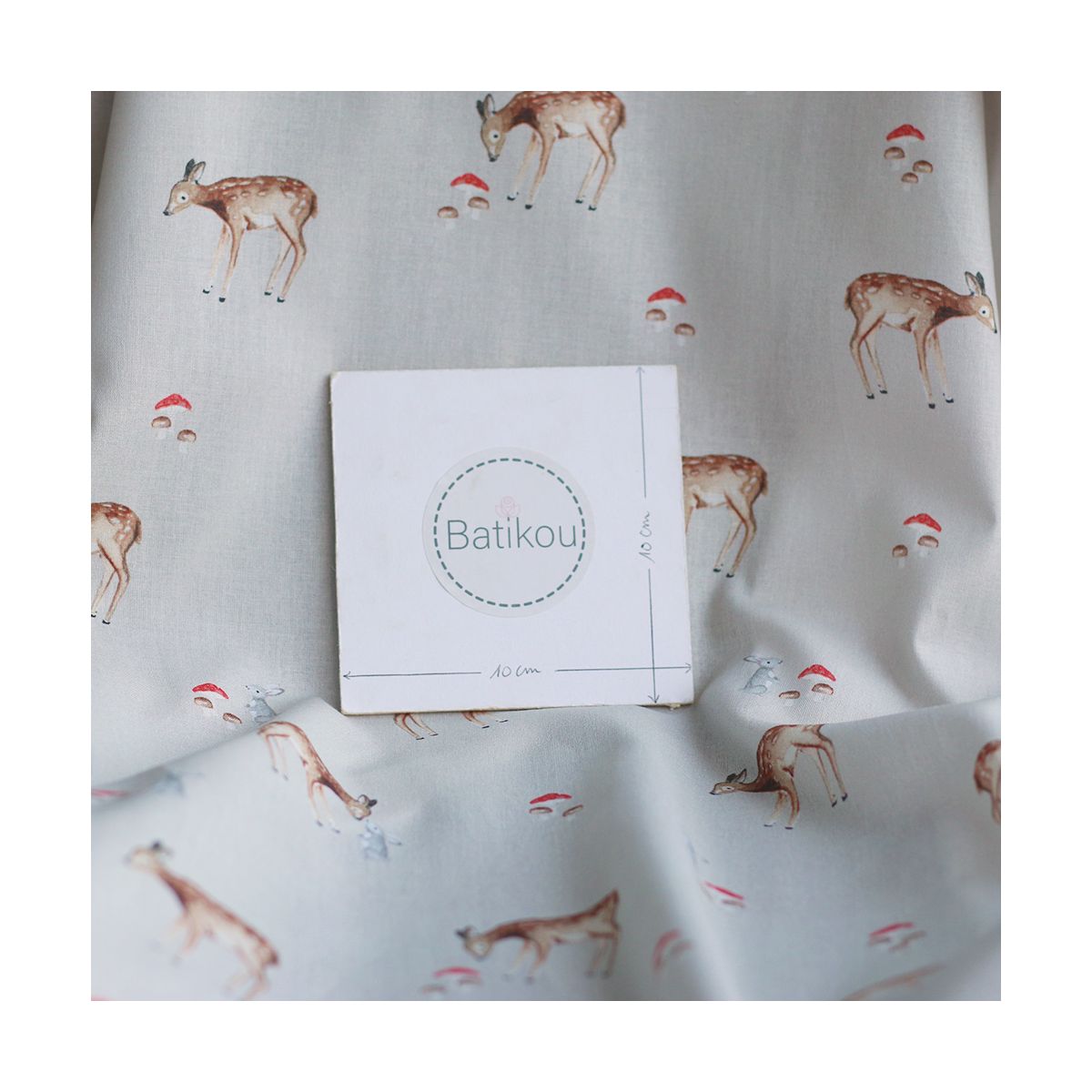 Bambi - Popeline de coton fond beige motif biche, lapin et champignons