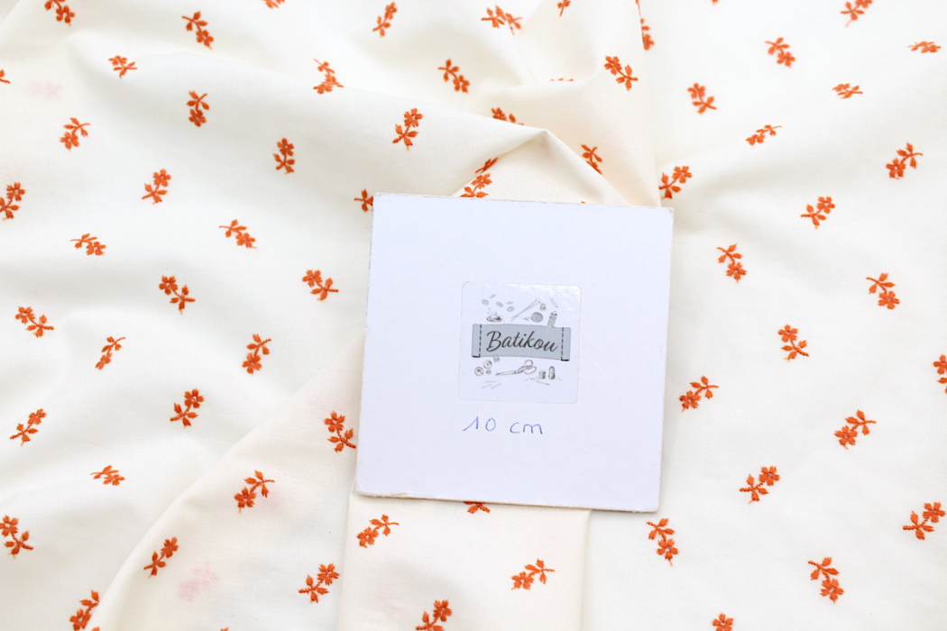Tissu coton organique broderies fleurs coloris orange