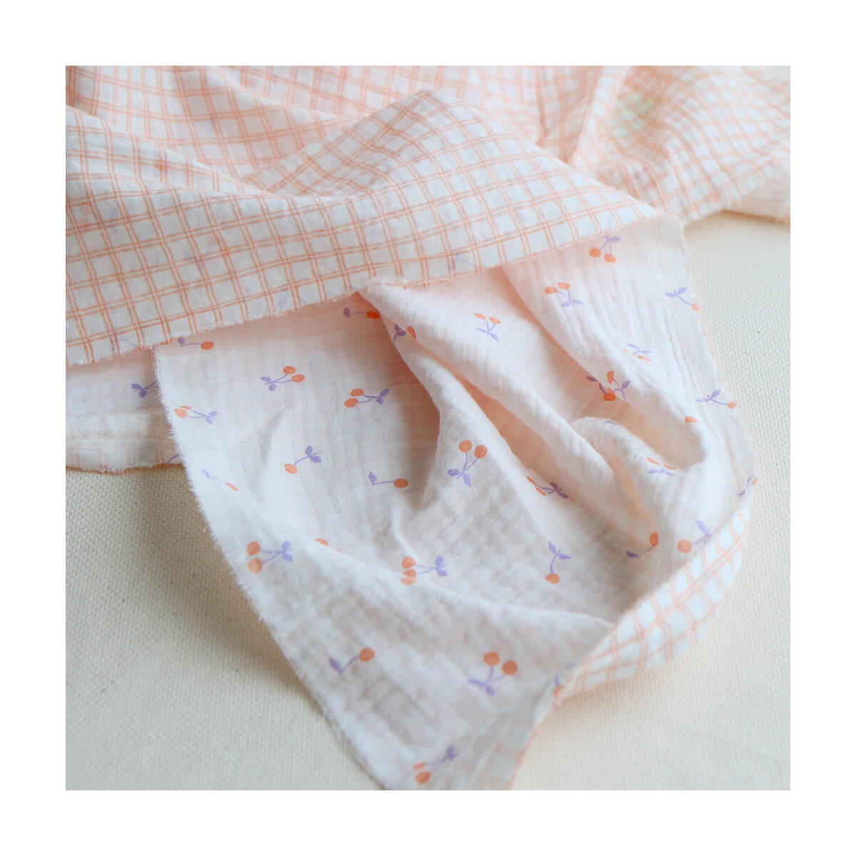 Cherry - Double gaze de coton double face coloris blanc cerises et quadrillage parme et orange Cherry - Double gaze de coton double face coloris blanc cerises et quadrillage parme et orange